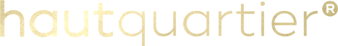 Goldener Kleinbuchstabentext mit der Schreibweise „hautquartier“ und einem eingetragenen Markensymbol (®) am Ende, auf schwarzem Hintergrund.